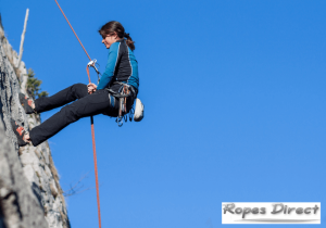 Woman using static ropes for abseiling